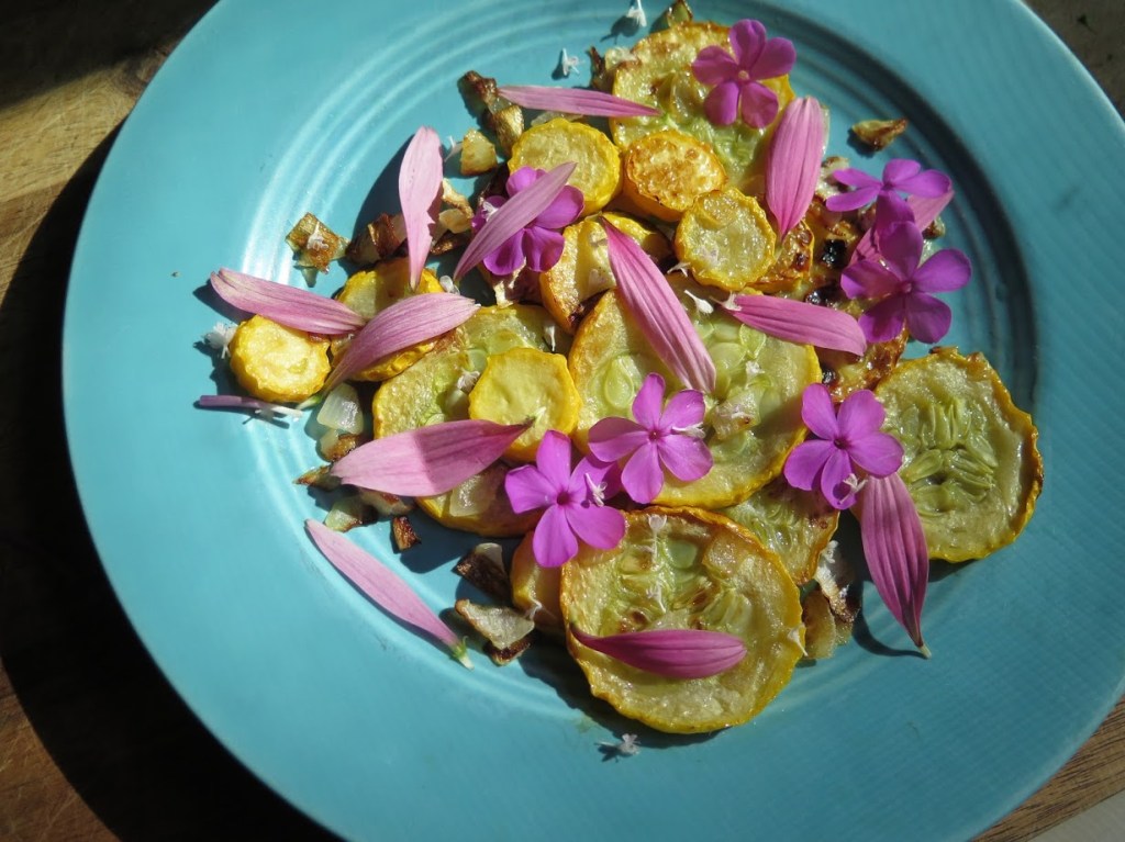 Garden phlox and purple coneflowers garnish yellow squash.